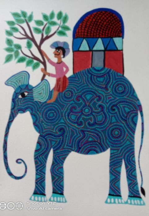  a mahout riding an elephant with a howdah