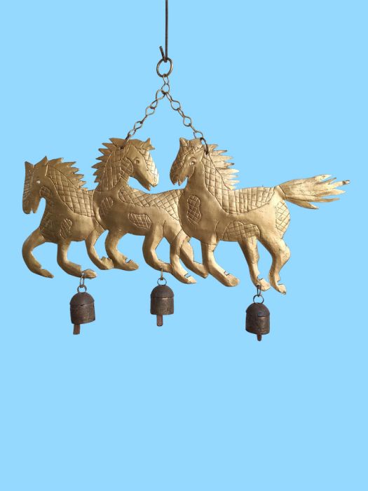 A herd of horses with bells under them