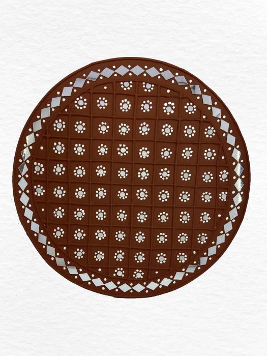 Traditional artistry of mud and mirror design by skilled artisans on chocolate circular disc