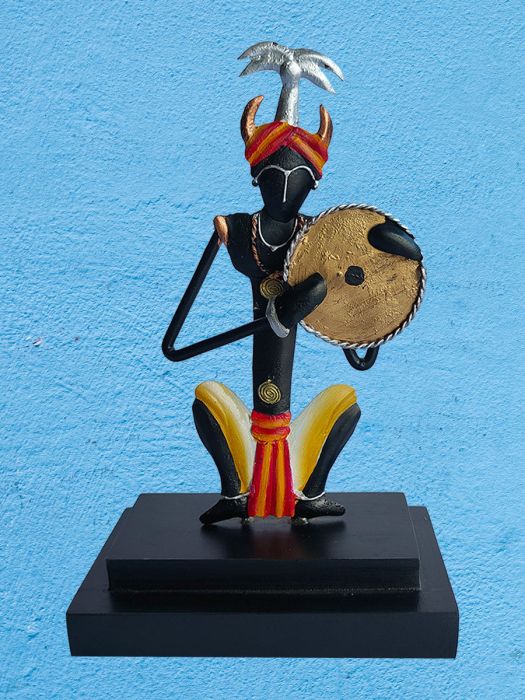 Handmade table decor of tribal drummer playing on his shoulder